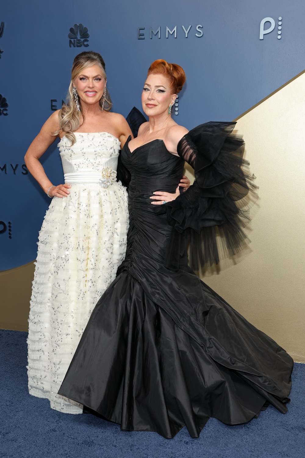 'Parent Trap' stars and longtime besties Elaine Hendrix and Lisa Ann Walter had an angel/devil theme going. Hendrix was a vision in an ornate white dress, reminiscent of Anne Hathaway's final ballgown in 'The Princess Diaries.' Walter's black mermaid gown was bold and well-fitted but would be more flattering without the tulle wings (Getty)