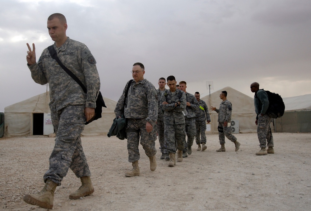 A U.S. army soldier flashes a V for victory sign as he begins his journey home, at the al-Asad Air Base west of Baghdad, Iraq, Nov. 1 , 2011 (AP Photo/Khalid Mohammed)