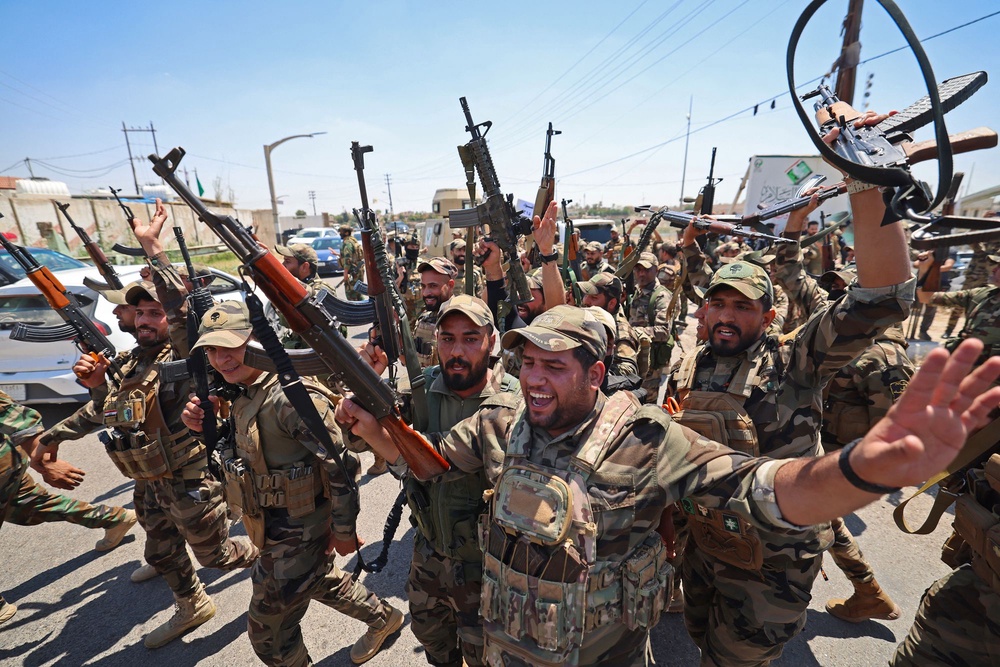 Members of Saraya al-Salam react during a ceremony in the city of Samarra on June 4, 2026, marking their separation from the Sadrist movement and their integration into the Iraqi security forces (AFP via Getty Images)
