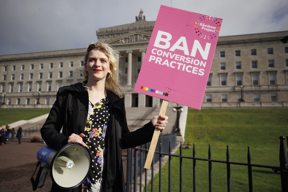 Alexa Moore from the Rainbow Project held a rally outside Parliament Buildings (Liam McBurney/PA) (PA Wire)