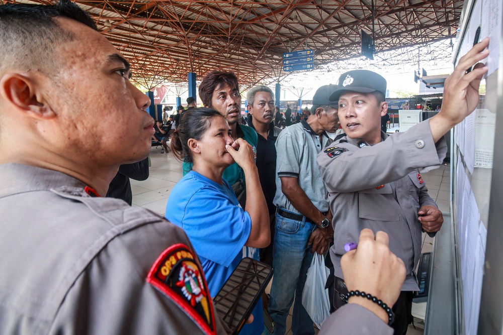 A woman reacts as police officers display a list of the victims of the Virgo Transport 8 ferry (AFP/Getty)
