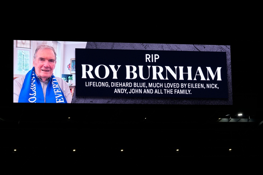 A message about the death of Roy Burnham, the father of Prime Minister Andy Burnham, is displayed on the screen during the Everton v Wolverhampton Wanderers match (PA)