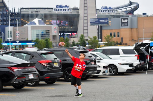 Lucas Teixeira, 8, throws a football outside Gillette Stadium prior to an NFL preseason football game against the Philadelphia Eagles (AP)
