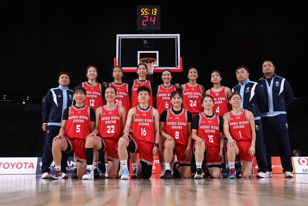 Hong Kong players and staff members pose for a team picture before the match (Reuters)