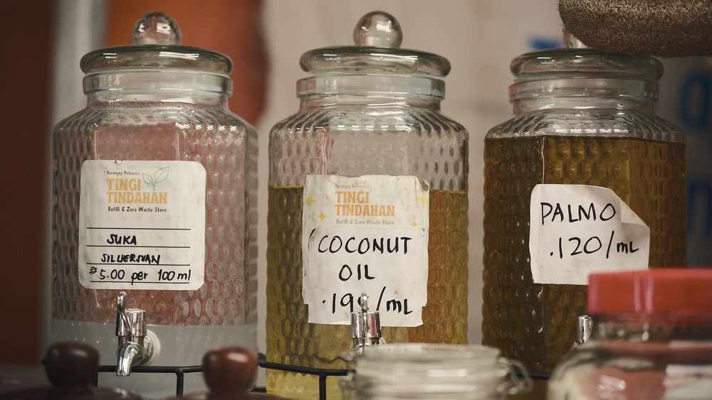 Bulk refill jars at a store where customers bring their own containers to buy vinegar, coconut oil and other everyday staples by the millilitre, rather than in single-use sachets (Mother Earth)