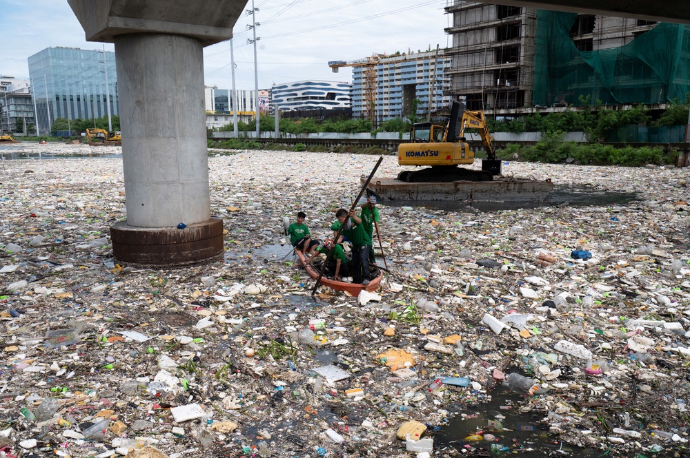 Workers on a plastic boat collect rubbish from a river in Paranaque City, suburban Manila, Philippines (AFP/Getty)