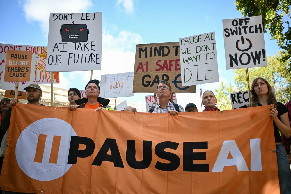 People hold placards and a banner during an ‘emergency protest’ by civic action group PauseAI UK outside Downing Street in central London on 16 September, 2026 (AFP/Getty)