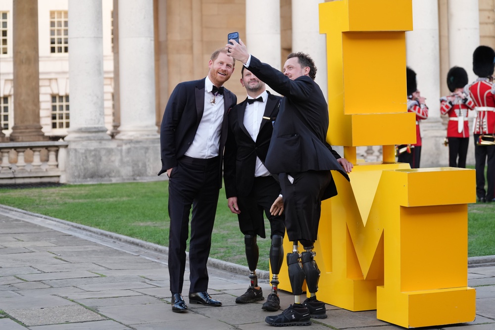 The Duke of Sussex has a selfie taken with Steve Arnold (centre) and Josh Boggi, as he arrives at the inaugural Invictus Spirit Awards (Ben Whitley/PA)