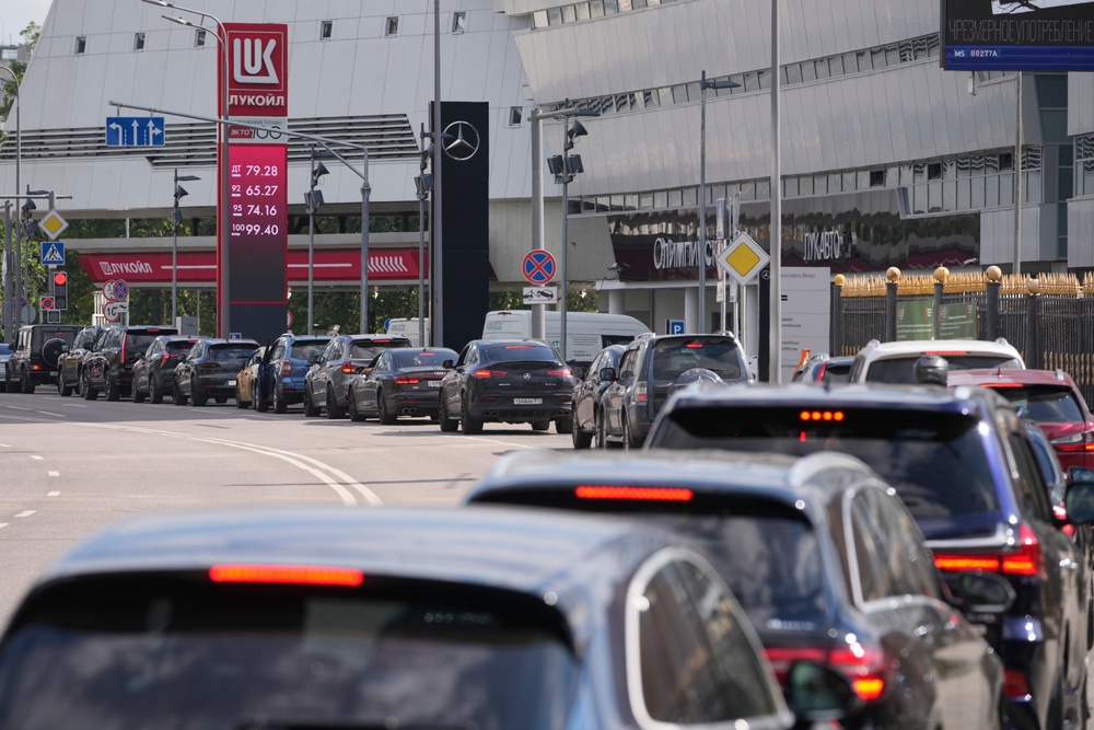Motorists line up at a Lukoil petrol station in Moscow (AP)