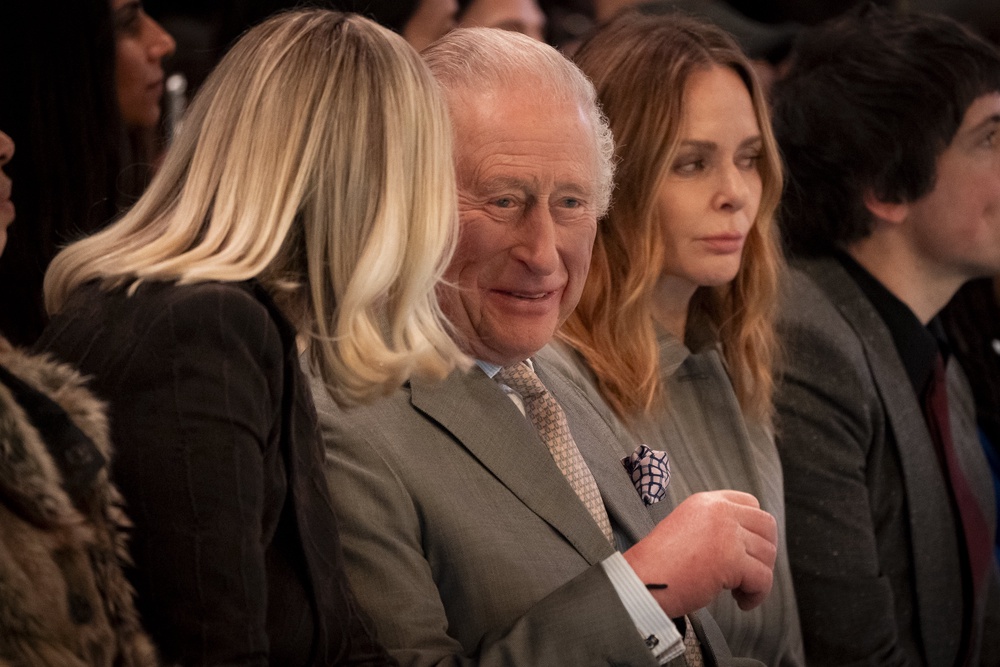 King Charles laughing with Laura Weir at Tolu Coker’s AW show in February (Aaron Chown/PA)