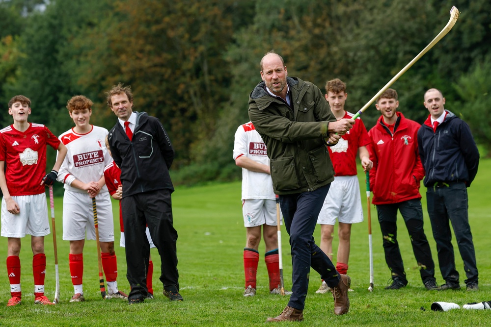 The Prince of Wales (known as the Duke of Rothesay when in Scotland) participates in the sport on the pitch while visiting the Bute Shinty Club. (PA)