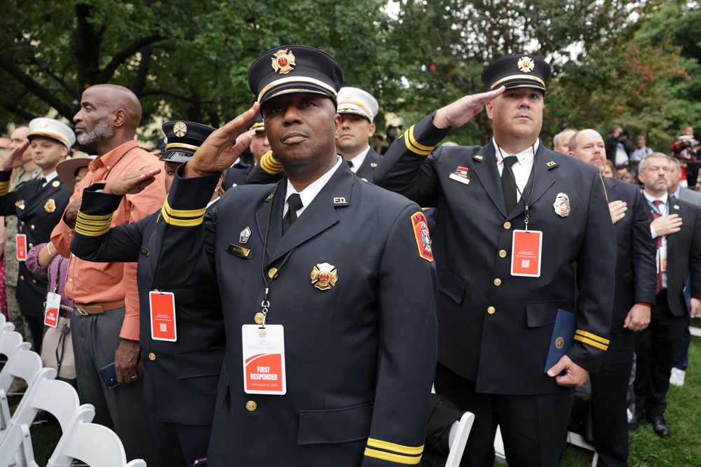 First responders salute during an observance ceremony marking the 25th anniversary of the September 11, 2001 (Reuters)