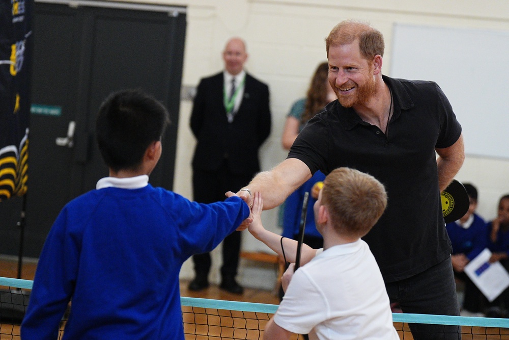 The Duke of Sussex shakes hands with pupils during his visit to Ninestiles School on Friday (PA)