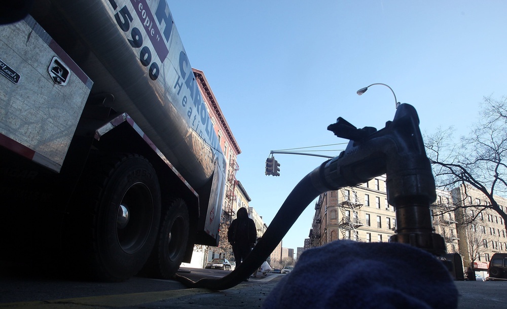 A South Carolina Heating Fuel employee delivers heating oil to a building in Harlem January 12, 2010 in New York City (Getty Images)