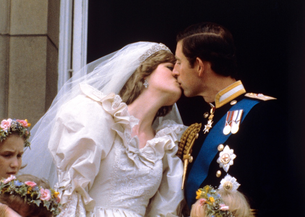 The newly married Prince and Princess of Wales kissing on the balcony of Buckingham Palace after their wedding ceremony at St Paul’s Cathedral on July 29 1981 (PA) (PA Archive)