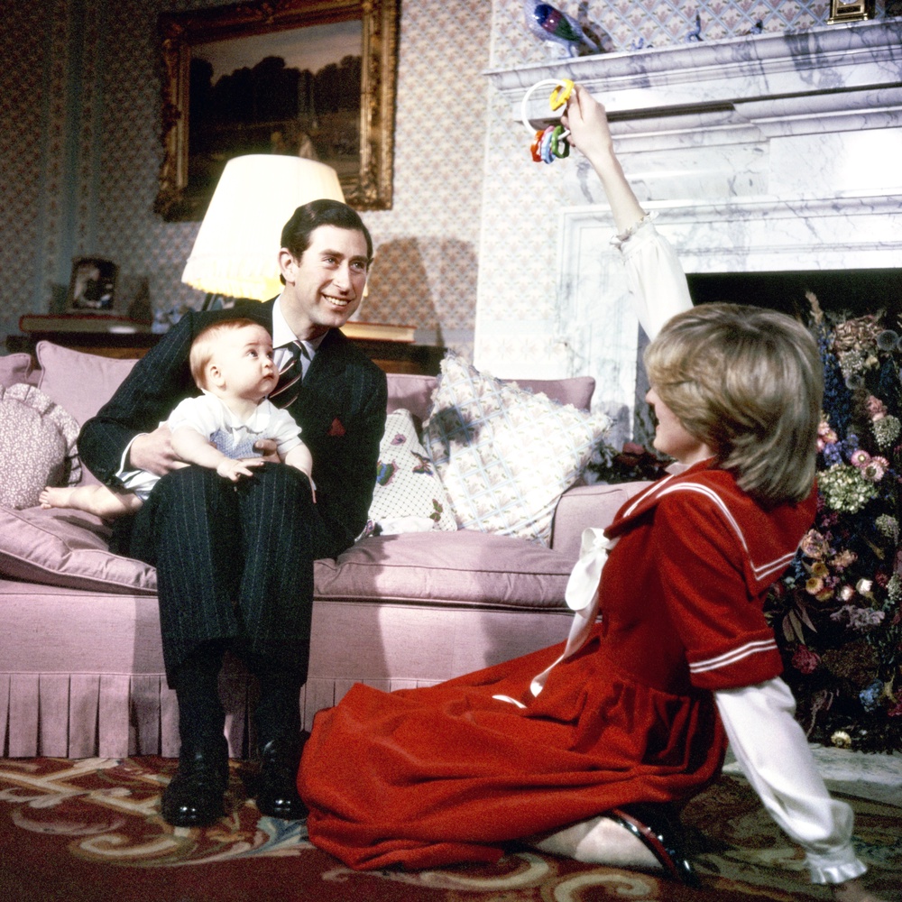 Charles, Diana and William during a photo session at Kensington Palace in December 1982. William was pictured sitting on his father’s lap while Diana attracted her son’s attention with a rattle (PA) (PA Archive)