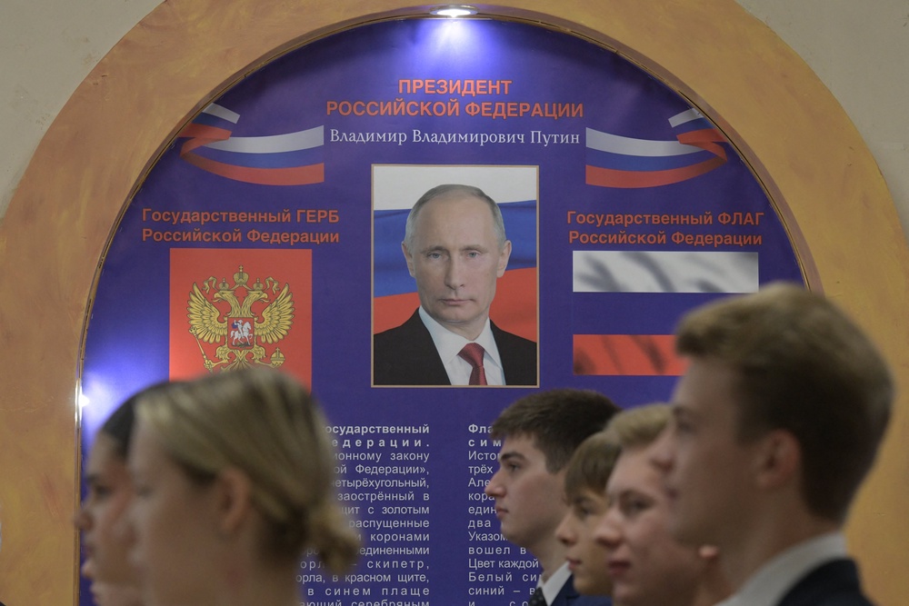 Students line up to sing the Russian national anthem as polls opened in Donetsk (AFP/Getty)