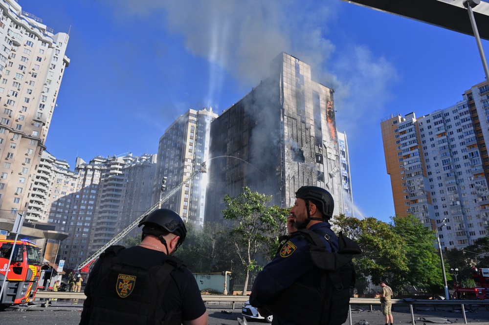 Police officers look at a burning office building following a Russian drone attack in central Odesa, Ukraine (Michael Shtekel/AP) (AP)