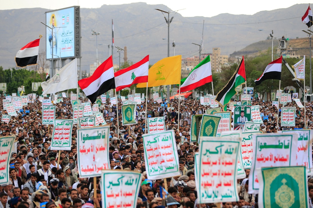 Supporters of Ansar Allah hold flags during a protest against Saudi intervention in Yemen on Friday (AFP/Getty)