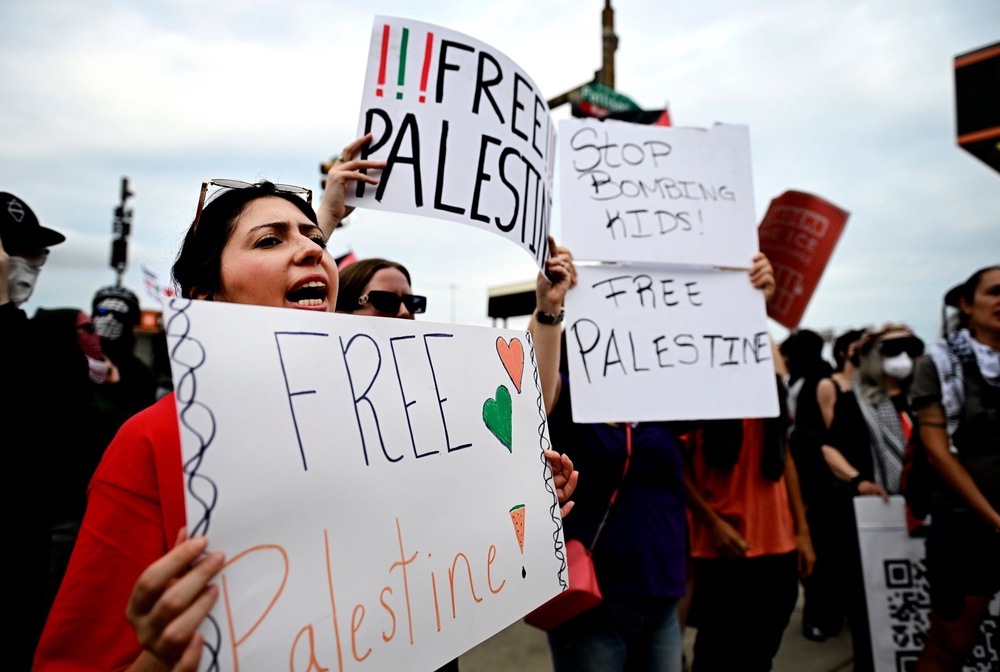Protesters hold 'Free Palestine' signs before Ed Sheeran's Philadelphia concert (AP)