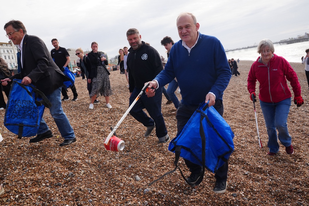 Sir Ed Davey took part in a litter pick on Brighton Beach (Stefan Rousseau/PA) (PA Wire)