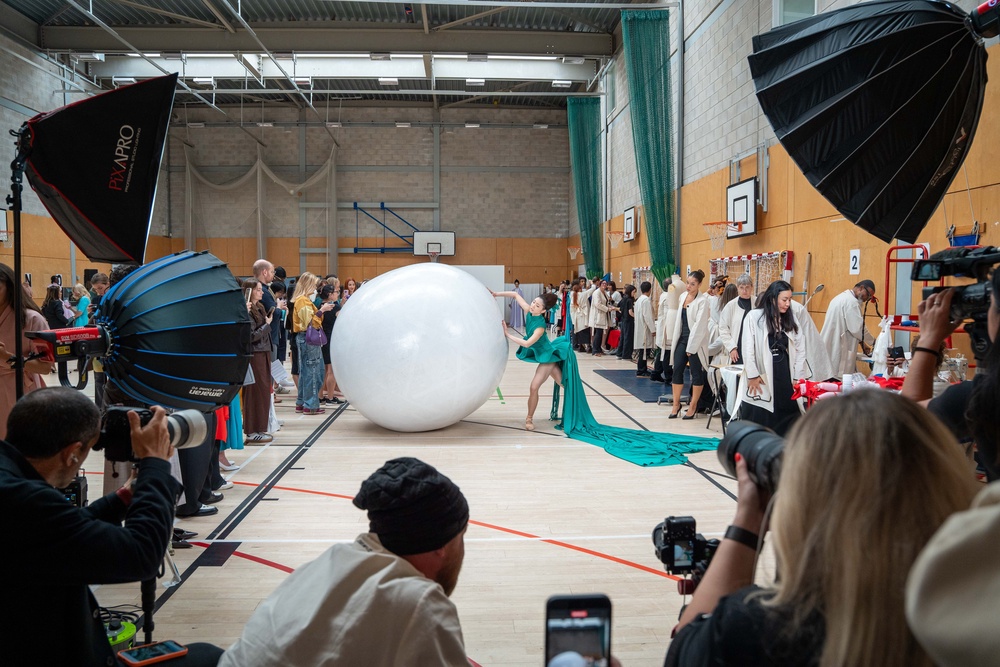 A boulder was brought out for a model to push up the runway (Jeff Moore/PA)