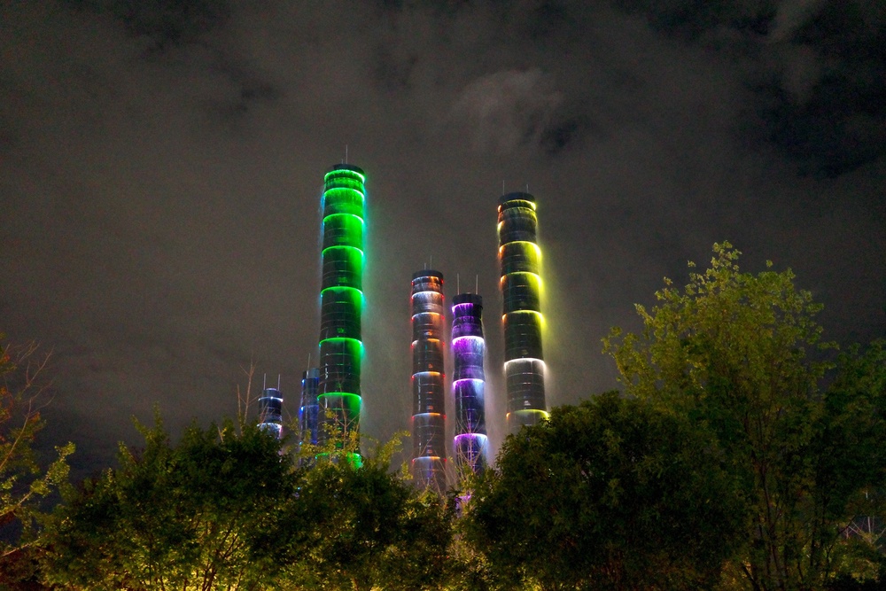 The Tower of Life installation consists of several bamboo-shaped pillars glowing in a succession of neon-lit rainbow colours (Venus Wong)