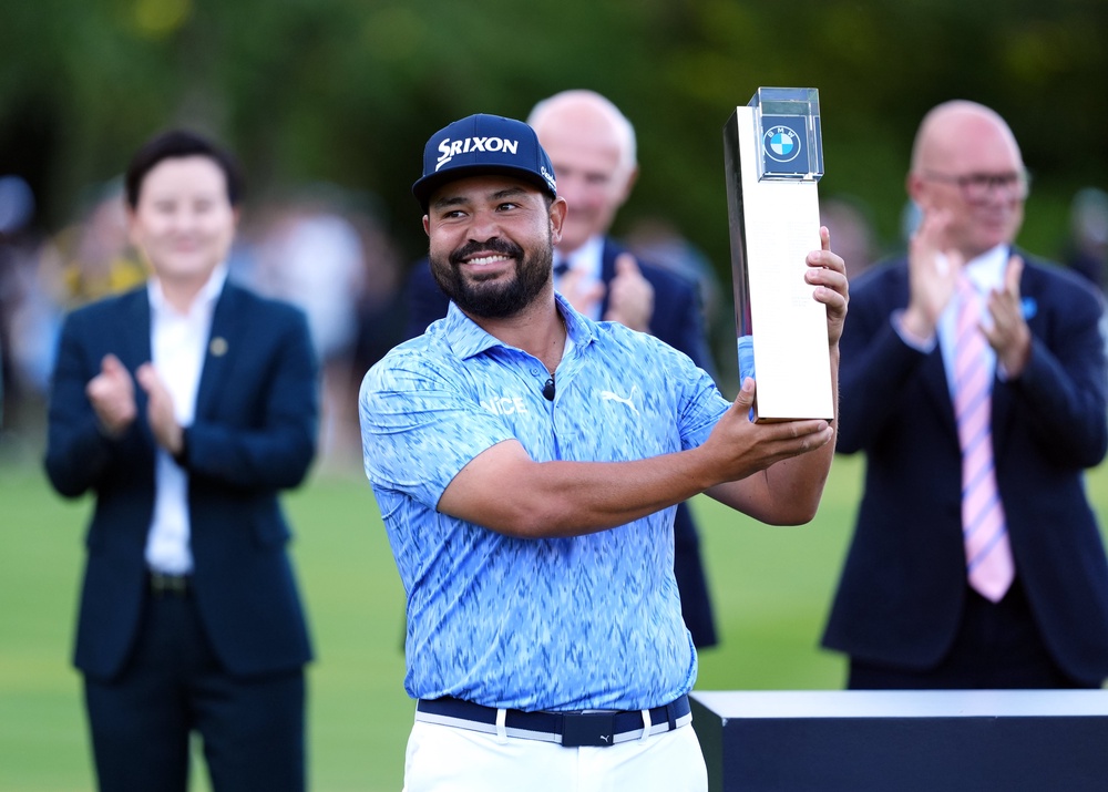 JJ Spaun celebrates with the trophy (PA)