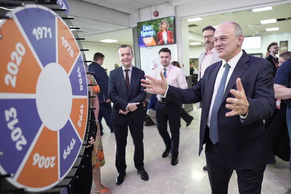 Liberal Democrat leader Sir Ed Davey views the stands as he tours the exhibition hall during the Liberal Democrat Party conference (Stefan Rousseau/PA) (PA Wire)
