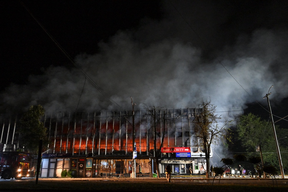 Firefighters work at the site of a shopping mall hit by an overnight Russian drone strike (Reuters)