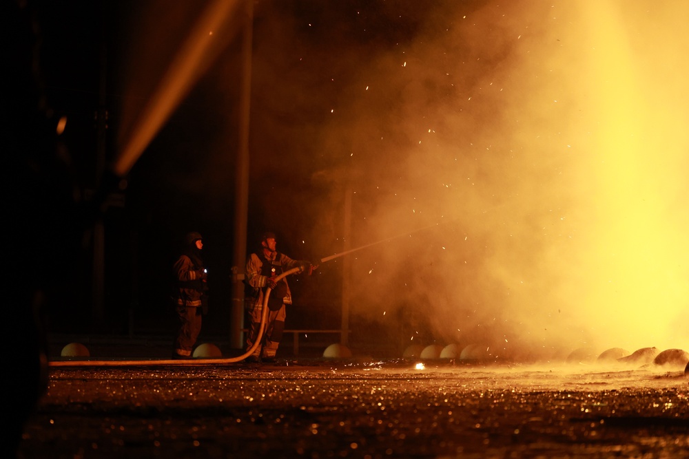 A firefighter directing a hose towards the flames engulfing the trade centre (AP)