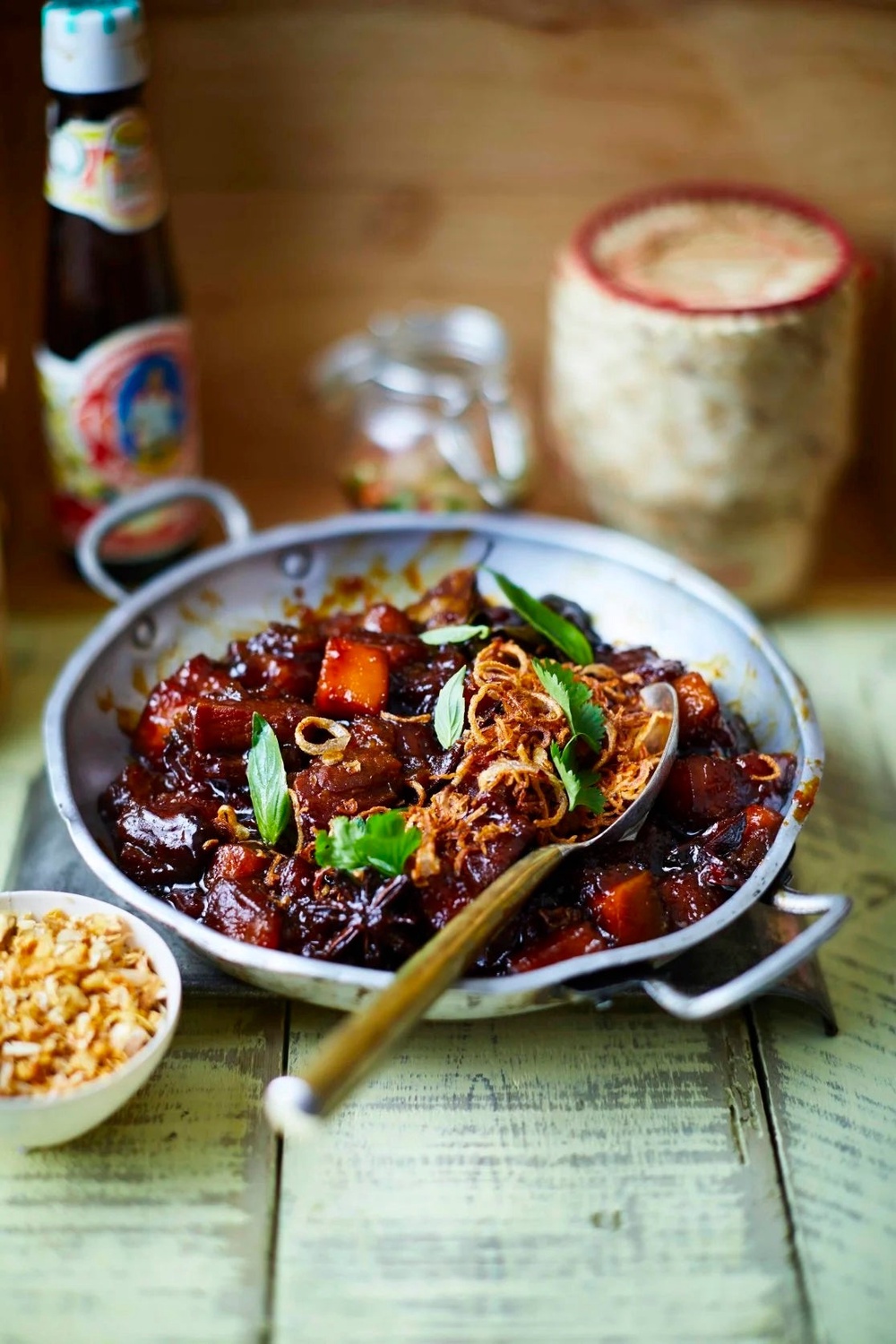 A dark, glossy braise of pork belly and pumpkin, finished with crisp shallots and plenty of fish sauce (Sebby Holmes/Farang/Payst)