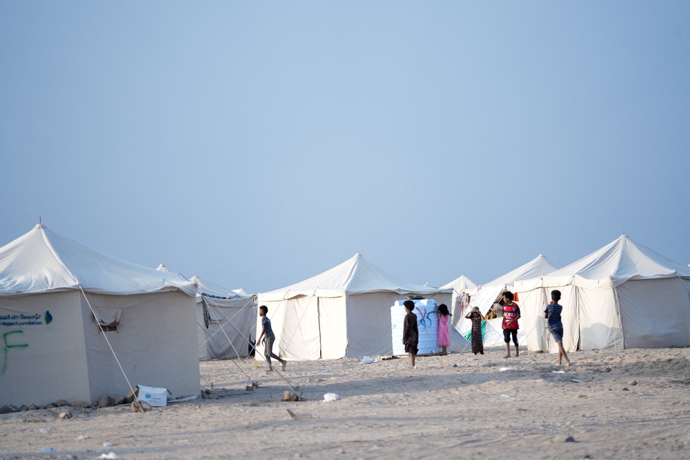 Children, who fled fighting between the Houthis and government forces in Red Sea coastline areas, stand at a camp for internally displaced people near Aden, Yemen (Reuters)