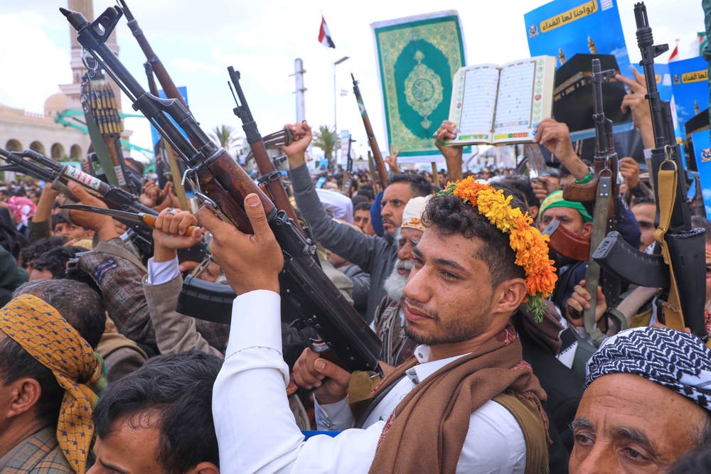 Supporters of Yemen's Houthi rebels raise their machine guns during a rally in support of the group and to protest Saudi Arabia's accusation that the Houthis targeted Islam's holiest site of Mecca, in Sanaa, Yemen, Friday, Sept. 18, 2026. (AP)