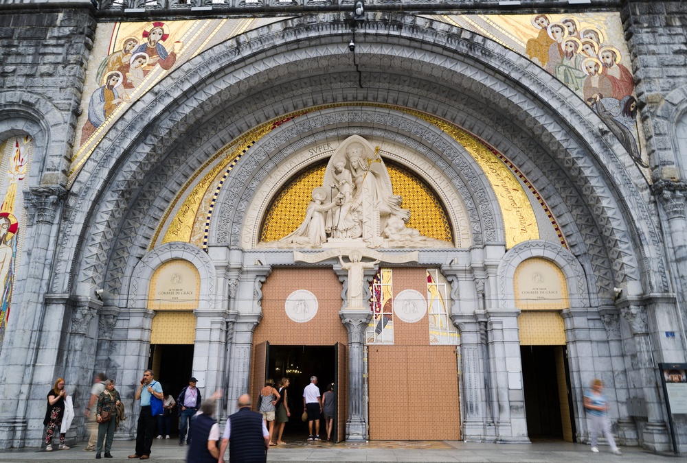 People enter the Notre-Dame-du-Rosaire basilica in Lourdes (AP)