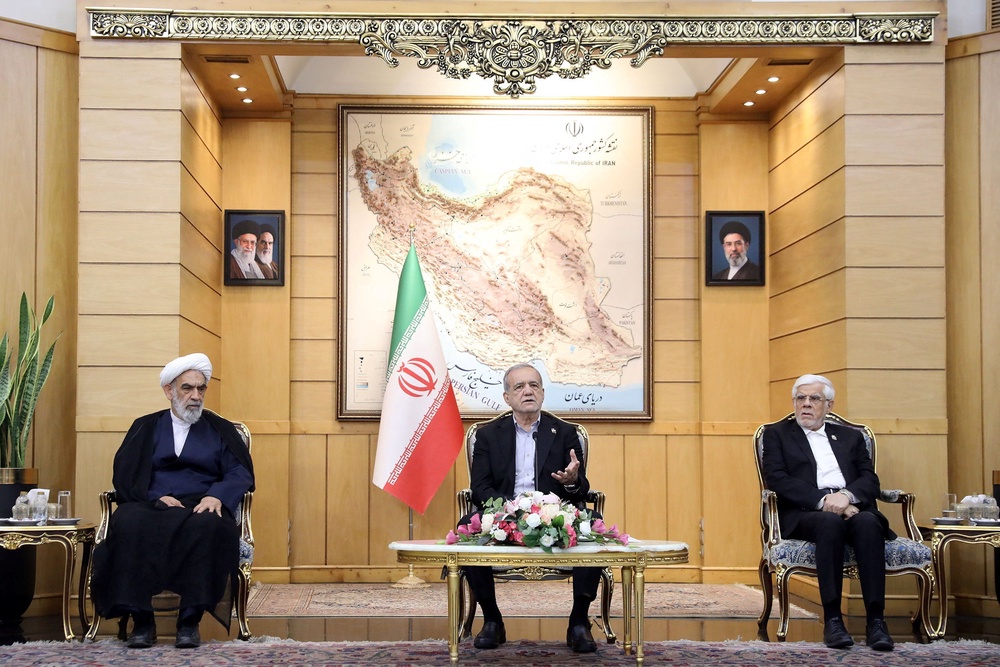 Iran’s president Masoud Pezeshkian (centre) speaks before departing for New York, at Mehrabad Airport in Tehran (Reuters)