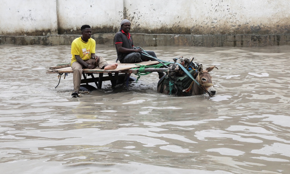 A donkey cart wades through flood waters following a heavy rainfall in Mogadishu, Somalia (Reuters)