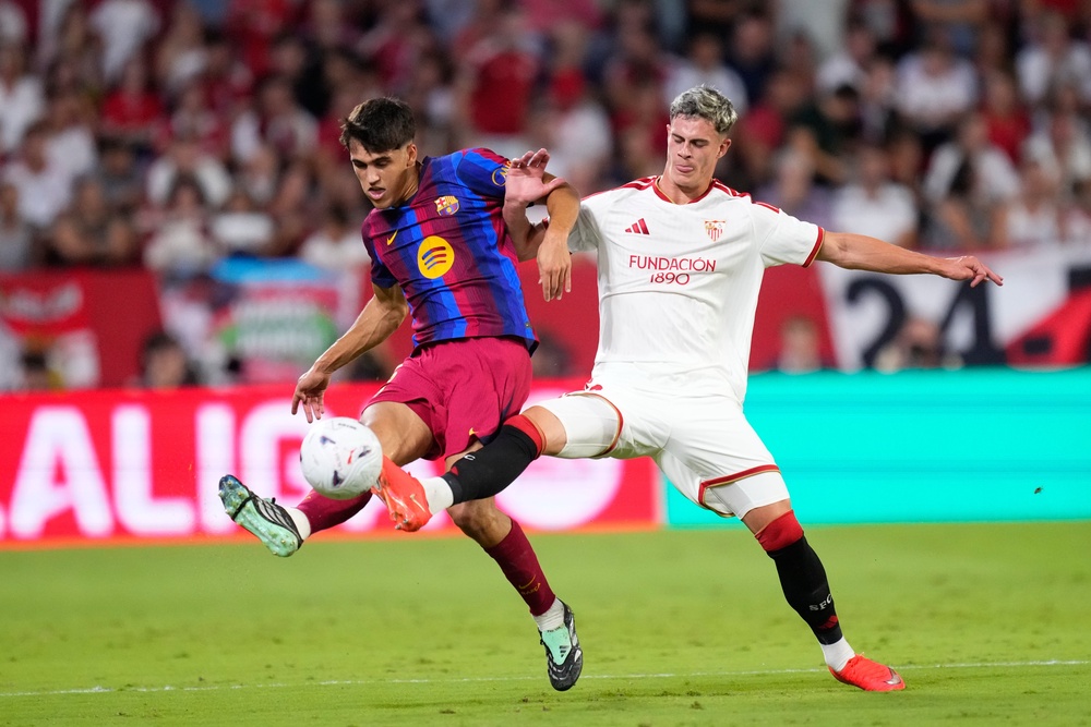 Robbie Ure (right) in action for Sevilla against Barcelona (AP)