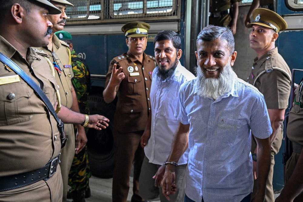 Police personnel escort the accused involved in Sri Lanka's Easter Sunday attacks of 2019 during the verdict in the trial at the Colombo High Court in Colombo on September 22, 2026 (AFP/Getty)