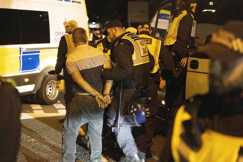 A person is led away by police during a protest in Gosport, Hampshire (Trevor Adams/PA) (PA Wire)