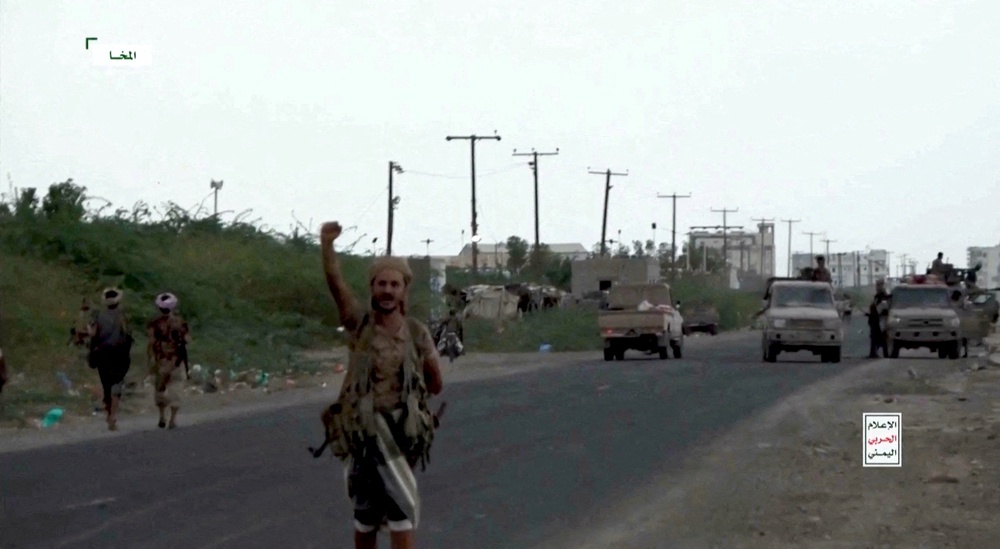 Houthi fighters take to the streets at a location given as Mocha, amid a lightning push west to seize land near the coast (Reuters)