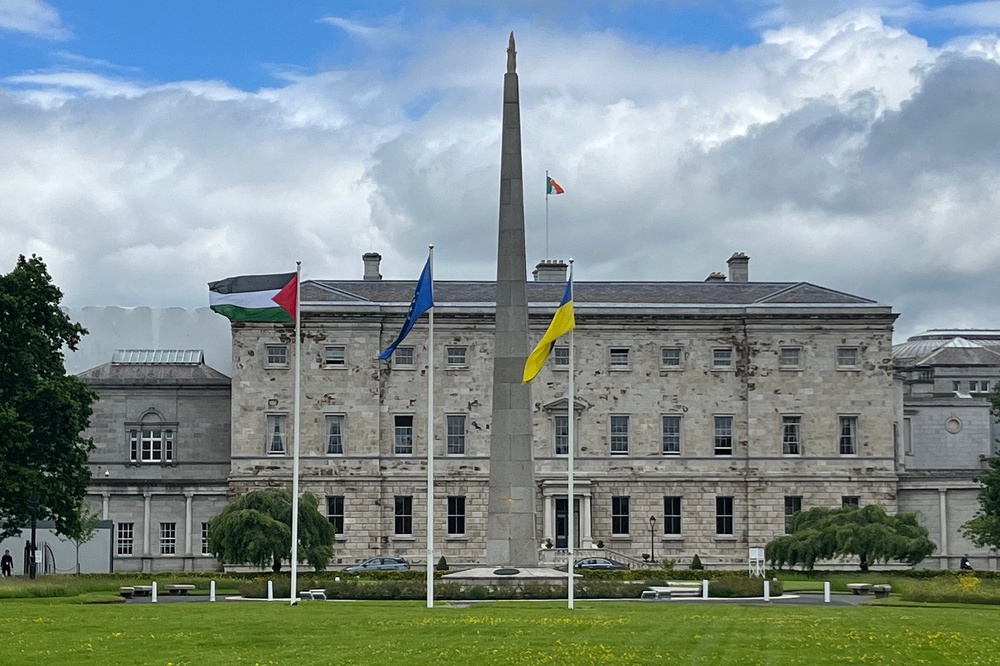 A Palestinian flag flutters alongside EU and Ukrainian flags outside Leinster House to mark Ireland's recognition of a Palestinian state (AFP/Getty)