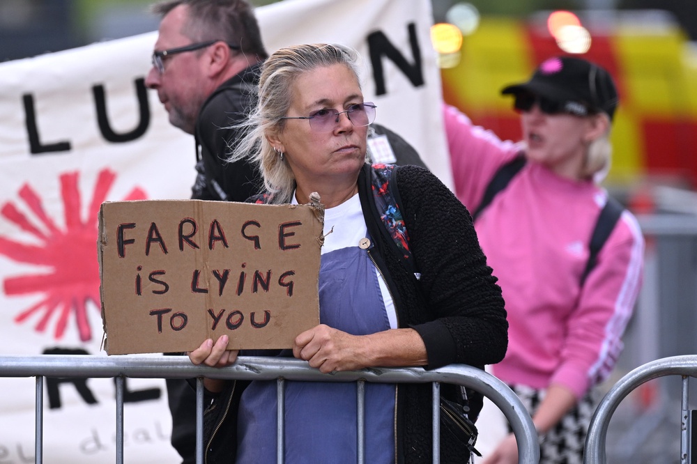 Protesters outside the venue on the second day of the Reform Party conference. (Getty)