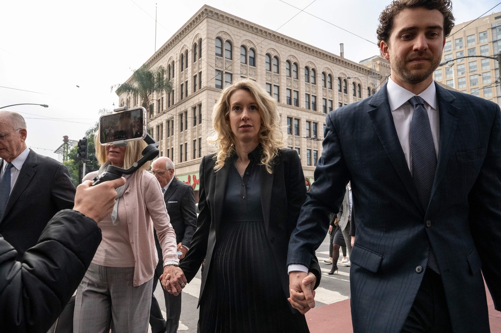 Holmes (center) and her partner William Evans (right), pictured in 2022, are at the center of the new documentary (AFP/Getty)