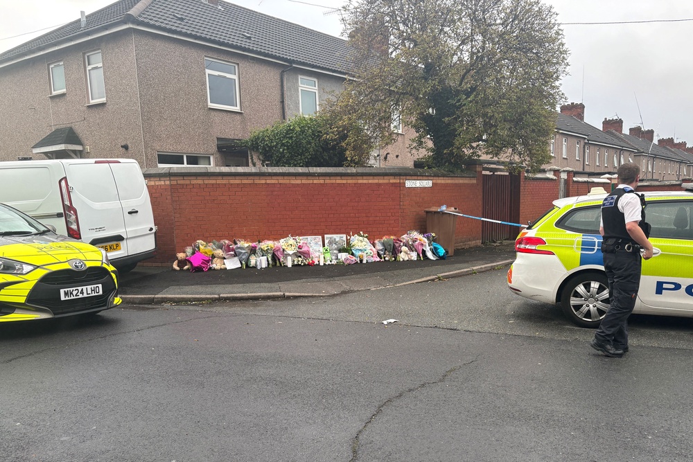 Floral tributes near to the scene in Stone Square in Bootle (PA Wire)