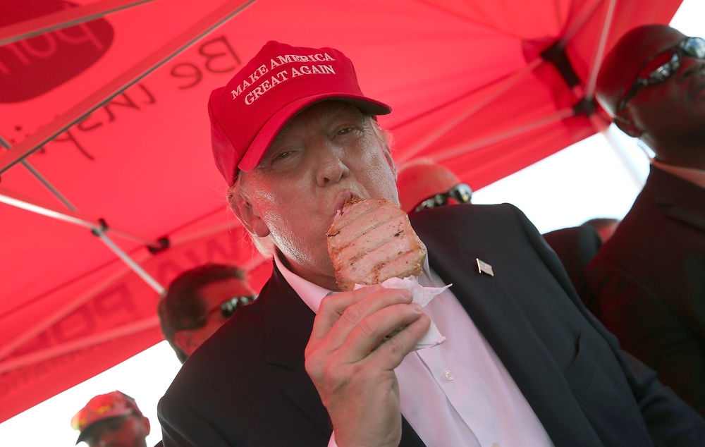 Republican presidential candidate Donald Trump eats a pork chop on a stick while attending the Iowa State Fair on August 15, 2015 in Des Moines, Iowa. (Getty Images)