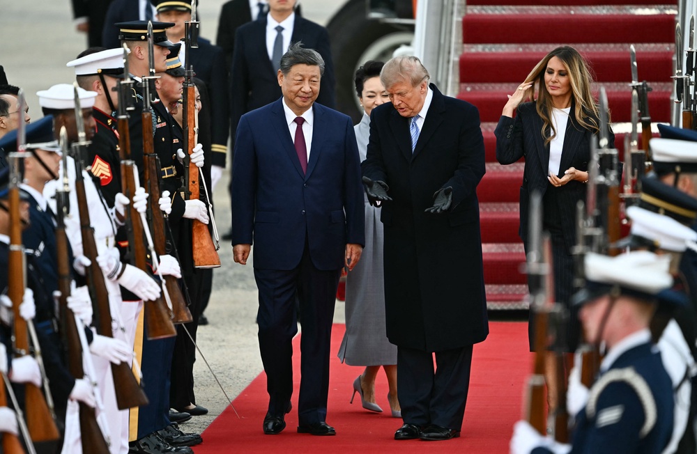 Donald Trump rolled out the red carpet in an unusual airport greeting for Xi Jinping on Wednesday (AFP/Getty)