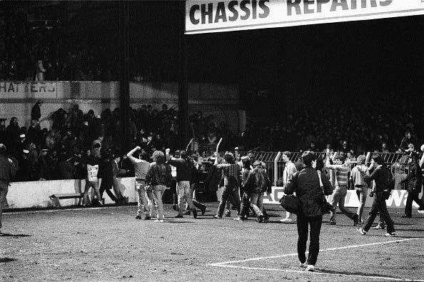 Fans invade the field during the 'Luton Riot' in 1985 (Getty Images)
