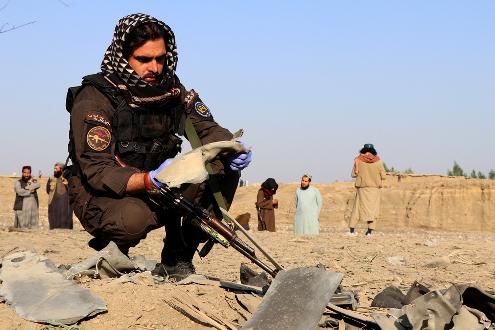 A member of the Taliban security forces inspects metal debris at the site of a partially damaged house following what Taliban officials say was a Pakistani airstrike in Gurbuz district, Khost province, Afghanistan, 24 September 2026 (Reuters)