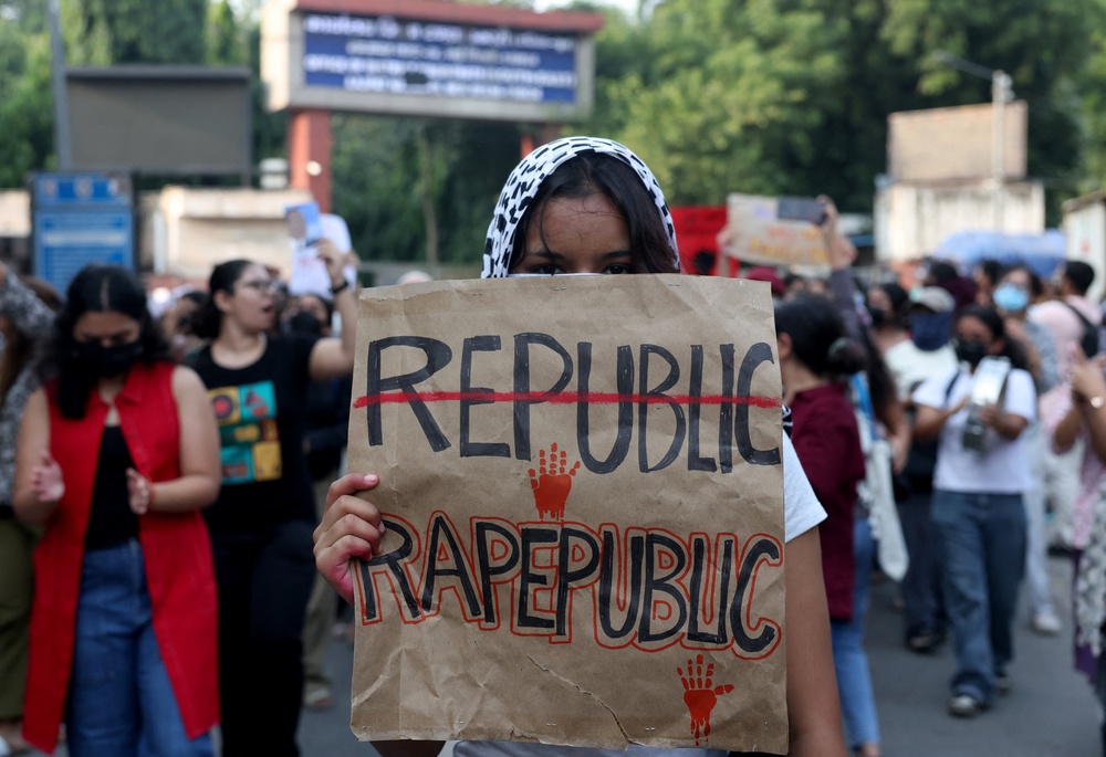 A college student holds a placard during a march demanding police action and better safety for women following the alleged gang-rape of a girl in Delhi, India, on 23 September 2026 (Reuters)